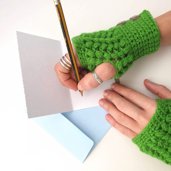 green cozy & warm crocheted mittens - in use - writing