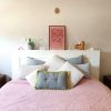 green & grey buttoned comfort cushion - in use bedroom