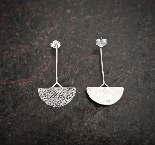 silver earrings with geometric patterns