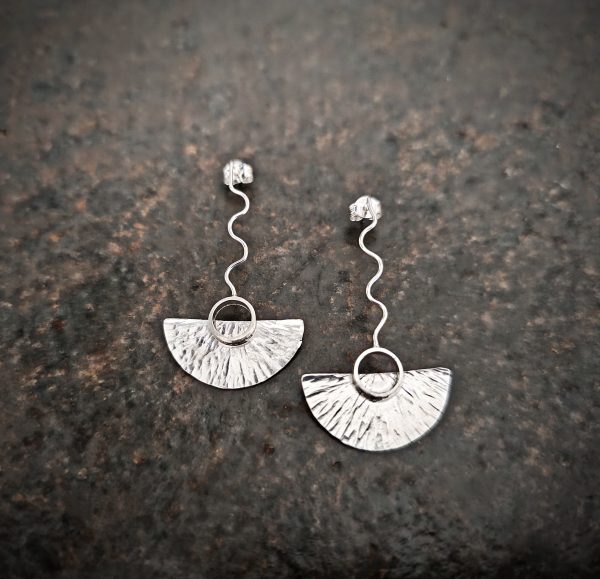 silver earrings with geometric patterns