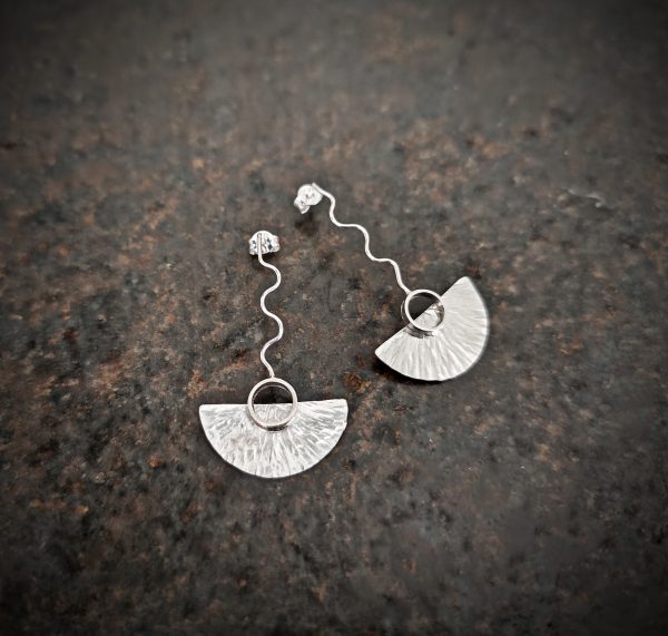 silver earrings with geometric patterns