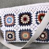 White granny square crochet bag with magnetic closure and felt lining