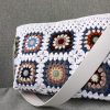 White granny square crochet bag with magnetic closure and felt lining
