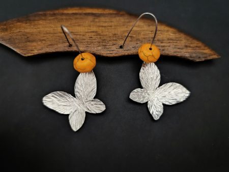 Butterfly hammered earrings with orange howlite stones