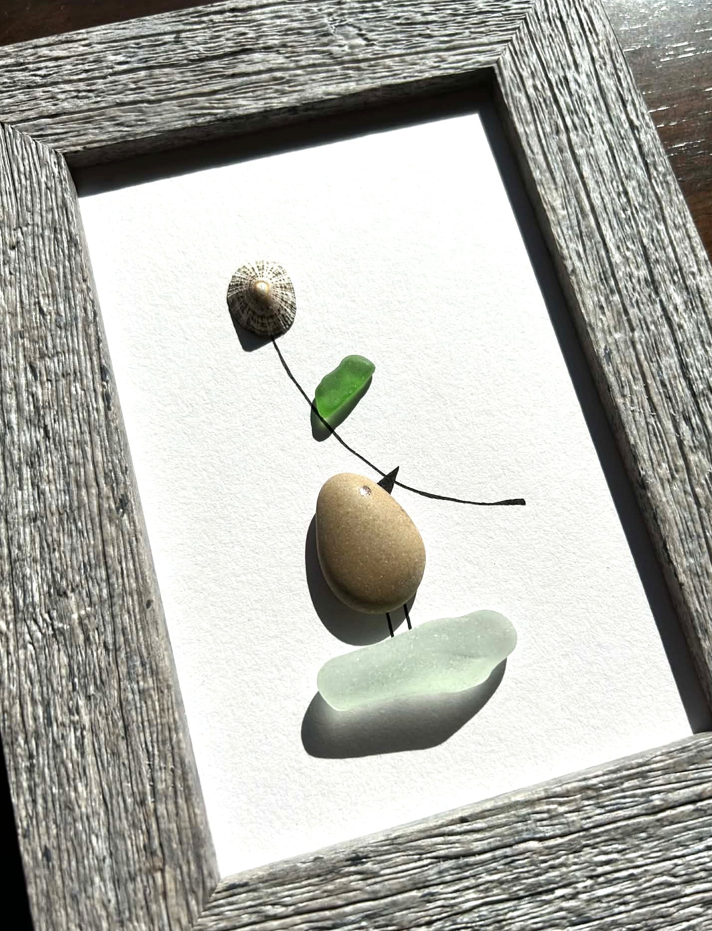 Minimalist Coastal Art – Pebble & Seaglass Scene with a Cute Bird Holding a Flower
